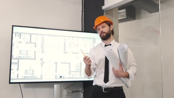 Confident Man Enginner Stand Near Digital Monitor and Presenting the Project
