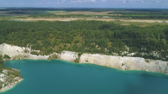 Slow Flight Over a Large Abandoned Gypsum Quarry. A Quarry Full of Blue Water.