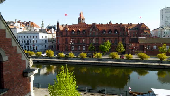 Main Post Office building in Bydgoszcz old town - aerial push back on a sunny day