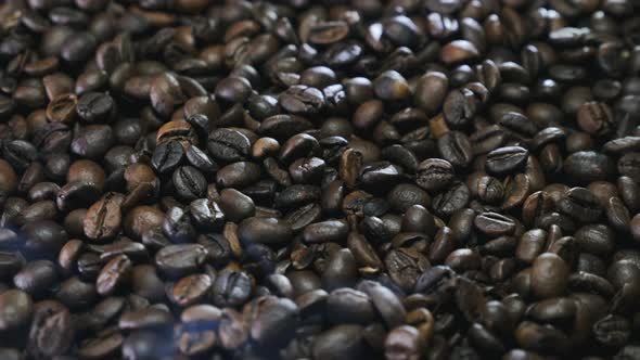 Fresh fragrant coffee beans with roasted smoke,