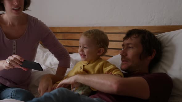 Caucasian family in bedroom at home