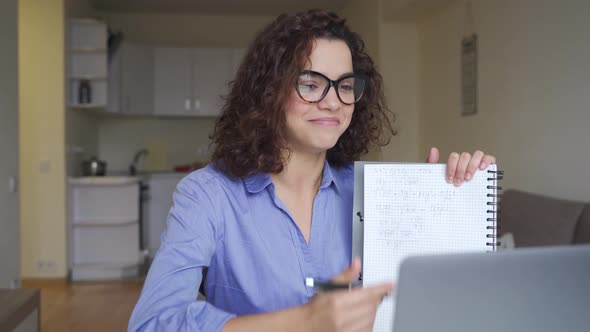 Happy Latin Young Female Teacher Working Online on Computer Laptop at Home