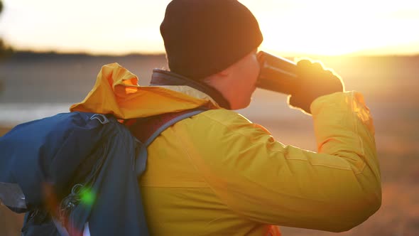 Hiker Young Tourist Enjoying Nature Drinking Hot Tea at Sunset