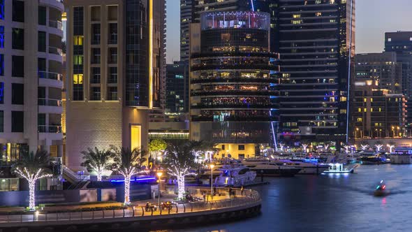 View of Dubai Marina Towers and Canal in Dubai Day to Night Timelapse