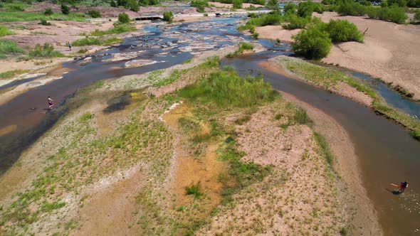 Aerial footage of the popular area on the Llano River in Texas called The Slab.  People are playing
