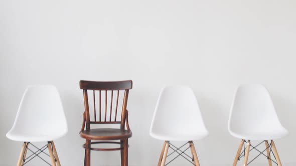 Four Chairs on a White Background Waiting for Unemployed People for an Interview