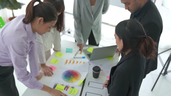 Business People Proficiently Discuss Work Project on Meeting Table