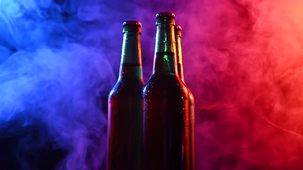 Three Bottles of Beer Spinning in Blue Pink Fog