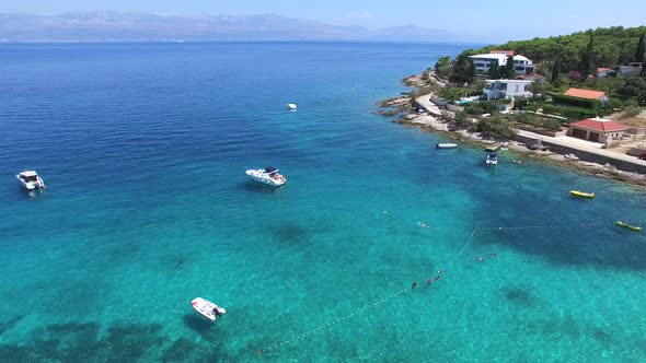 Flying over motorboats at sandy beach on the island of Brac, Croatia