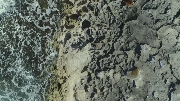 Topdown view along Volcanic rocky coastline, turquoise water color, Hawaii