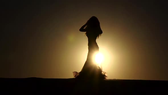 Professional Dancer Dances Gracefully Against the Background of a Hot Sunset, Silhouette, Slow