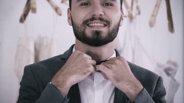 Man in Formal Suit Getting Dressed in Dressing Room for Work or Wedding