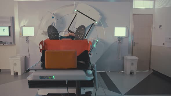 Patient Getting Radiation Therapy Treatment Inside A Modern Radiotherapy Room