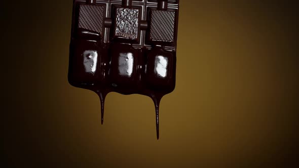 Chocolate Bar with Melted Chocolate Syrup Dripping Flowing Over Dark Brown Background Confectionery