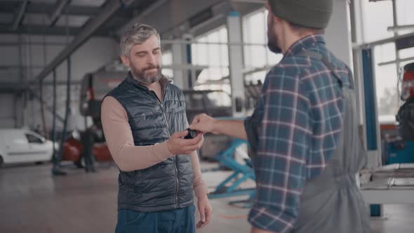 Auto Mechanic Handing Car Keys to Client