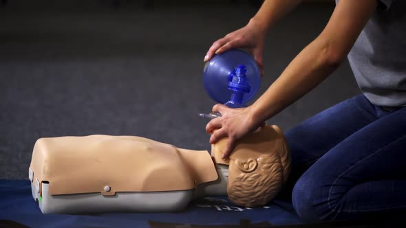 Resuscitation during first aid training. First aid instructor showing resuscitation technique on dum