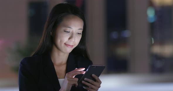 Businesswoman Use of Smart Phone in Hong Kong City at Night