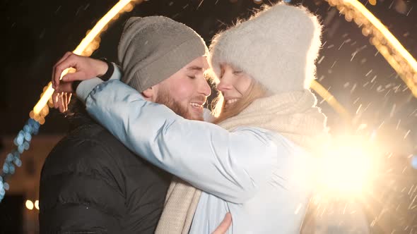 An Attractive Couple in Love a Stylish Couple Wearing Warm Clothes Cuddling Together and Looking