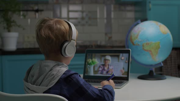 School Boy Studying Math with Senior Teacher Online Using Tablet Computer for Distance Learning From