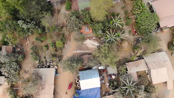 Aerial shot of house construction in Battambang Cambodia then cutting away into the horizon
