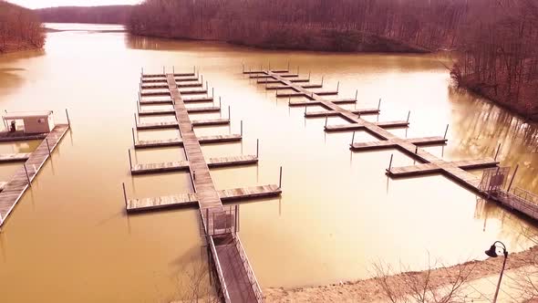 Aerial footage of boat slips at a marina on an icy lake during the winter at a state park