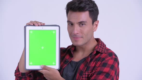 Face of Happy Young Hispanic Hipster Man Showing Digital Tablet