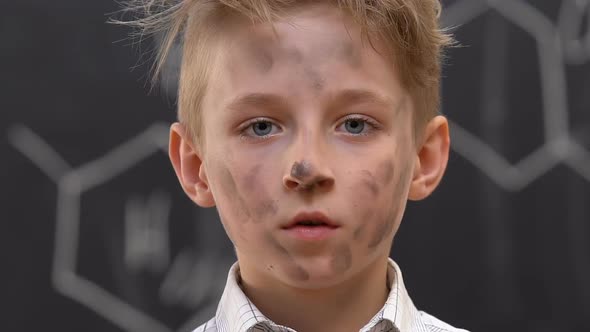 Shocked Boy With Dirty Face Shrugging Shoulders, Explosion at Chemistry Lesson