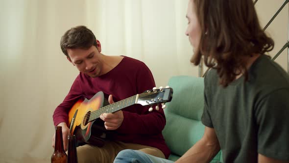 Two Friends are Playing Guitar and Singing Songs