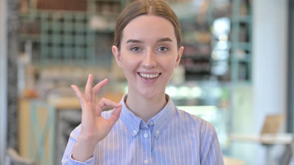 Portrait of Ok Sign By Joyful Young Businesswoman 