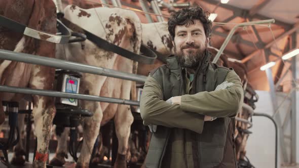 Man Posing near Carousel Milking Parlor