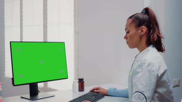 Dentist Working with Horizontal Green Screen on Computer