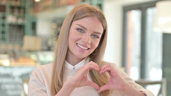 Portrait of Heart Shape By Young Woman Hand Sign