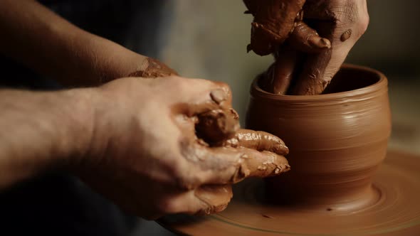 Man and Woman Hands Making Clay Pot in Pottery