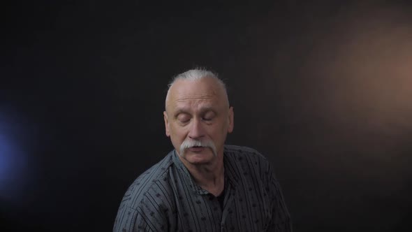 Serious Grandfather with Mustache Imitates Flying Disk Game