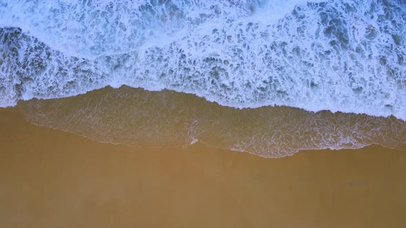 Aerial view top view video beautiful closeup shot beach and seawater on wave