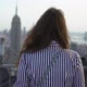 Girl on Rooftop Looks Over New York City Panoramic View at Manhattan at Sunset - VideoHive Item for Sale