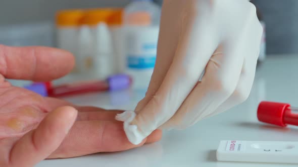 Nurse in Protective Glove Disinfect Patient and Pricks a Finger for Blood Samlping