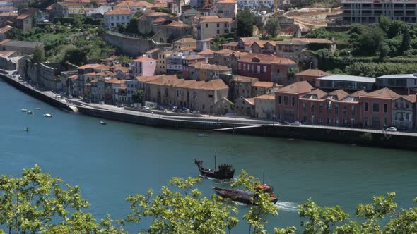 Scenic Douro River Landscape And Lined-up Residential Buildings With Traditional Wooden Boats Naviga
