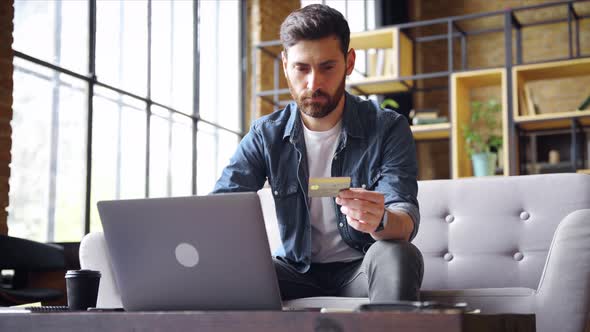 Caucasian Business Man Holding Credit Card Using Laptop for Online Payment