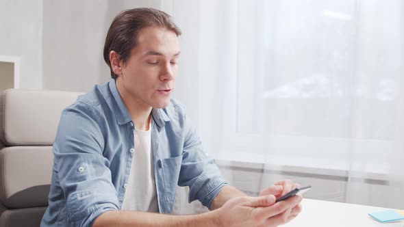 Workplace of freelance worker at home office. Young man works using computer.