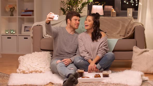 Happy Couple Taking Selfie By Smartphone at Home