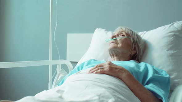 Elderly Woman Lying on Bed in Hospital Ward