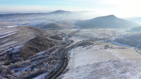 Aerial View of a Winding Road With Driving Cars in a Frosty Winter Sunny