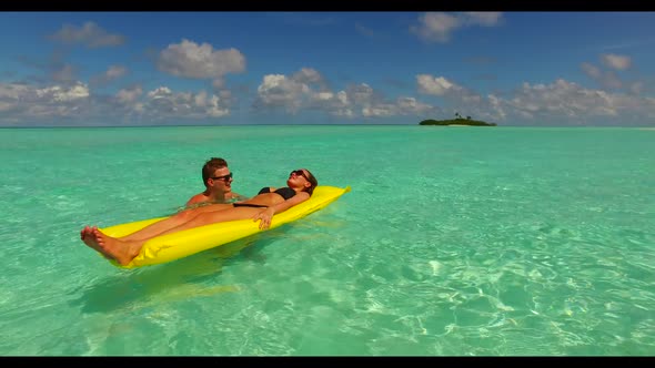 Romantic couple engaged on relaxing resort beach wildlife by aqua blue ocean with white sand backgro