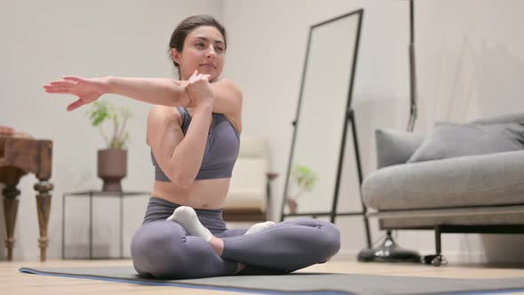 Young Indian Woman Doing Stretches on Yoga Mat at Home