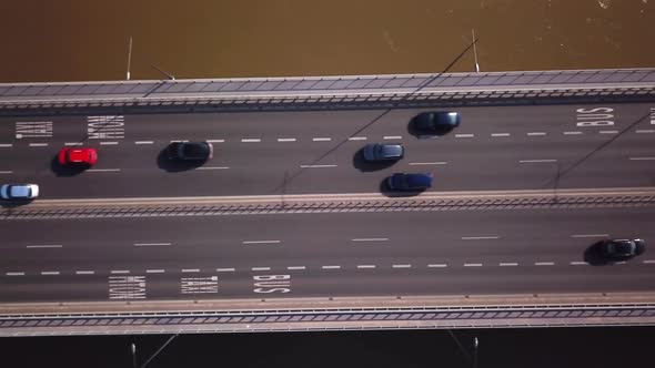 Aerial shot focuses on the traffic on the bridge. Cars driving. 4K