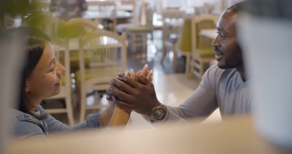 View Behind Shelf of African Couple on Date in Cafe