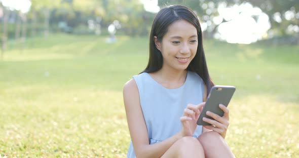 Woman use of smart phone in the park