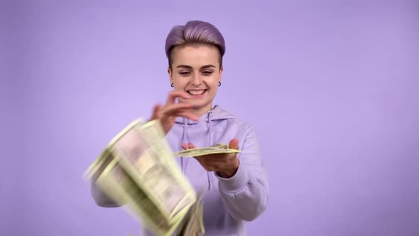 Young Person Gen Z Throwing Bunch Money on Camera Isolated on Purple