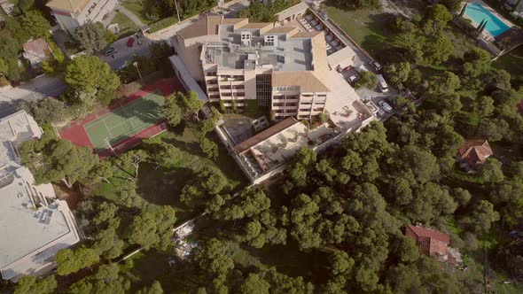 Aerial view of a residential building, surrounded by trees in Greece.